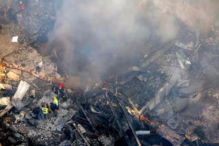 Firefighters attempt to extinguish a fire following an Israeli strike at the Corniche al-Mazraa neighbourhood of Beirut on Wednesday